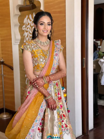 A full-length view of the bride's colorful Myra ceremony outfit.
