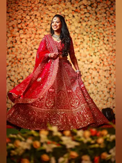A twirling shot that captures the grandeur of her red lehenga. The makeup is designed to be both beautiful and long-lasting, perfect for a night of celebration.