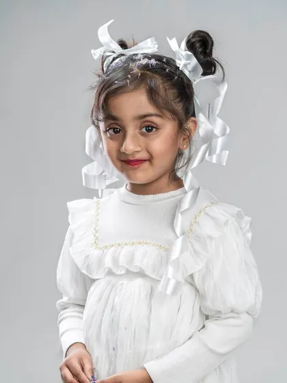 A duplicate of image 121, this portrait captures the innocent and classic beauty of a girl with ribbons in her hair.