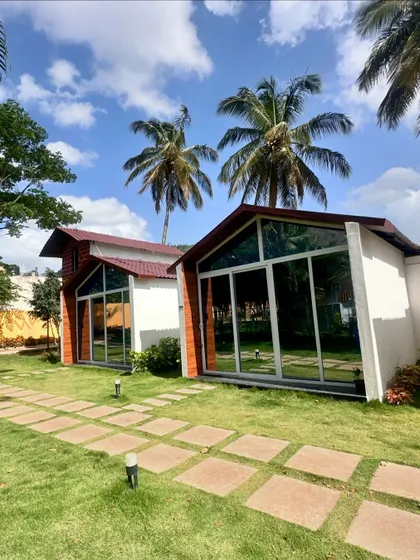 Our glass-fronted cabins at Nandi Hills offer stunning views and a modern aesthetic, blending comfort with the beauty of the surrounding nature.