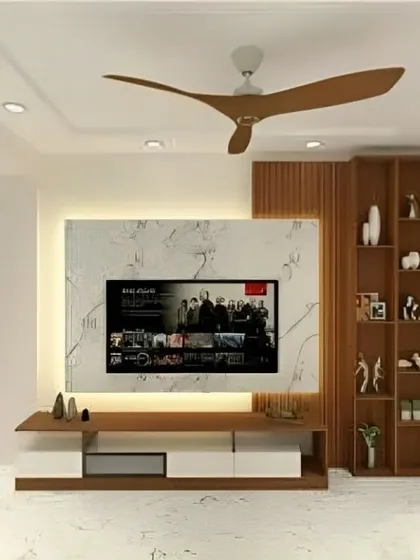 We designed this clean and contemporary TV unit with a white marble-finish back panel and integrated ambient lighting. The console combines white drawers with a central wood-finish shelf, paired with a vertical wooden bookshelf for added storage and display.