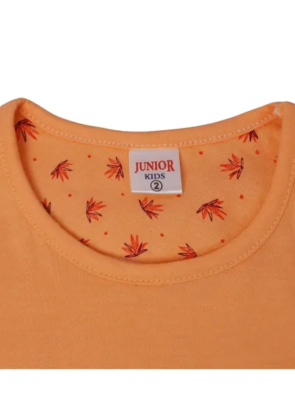 A detailed close up of the neck and brand tag of a 'Junior Kids' t-shirt. This shot highlights the quality of the fabric and the brand detail, which is important for apparel photography.