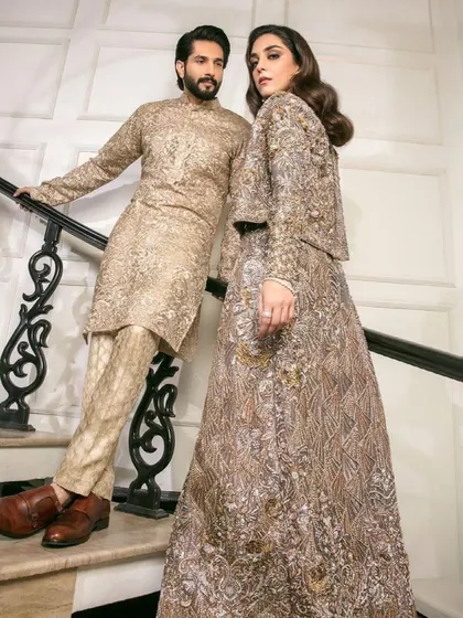 Here you can see how the intricate patterns on both outfits, though different, share the same color story and design language, creating a harmonious look.