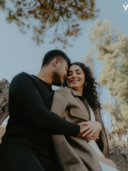 A close, intimate portrait of a couple in a Kashmir forest, their genuine smiles and warm embrace showing their deep connection. This natural light couple portrait feels both personal and scenic.
