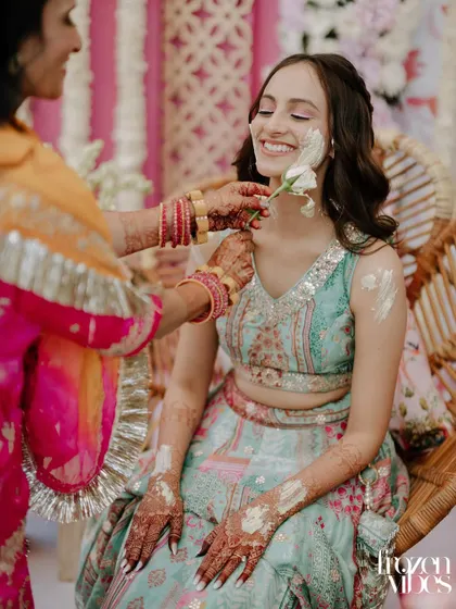 Another angle of the gentle Haldi application. These close-ups focus on the personal connections and traditions of the day.