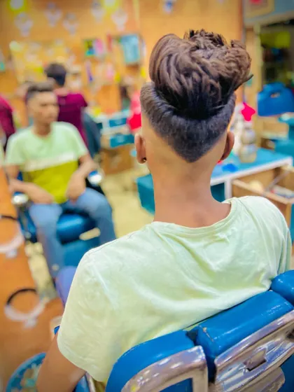 The back view shows the precision of the V-cut neckline. This detail adds a sharp, custom finish to the overall fade haircut.