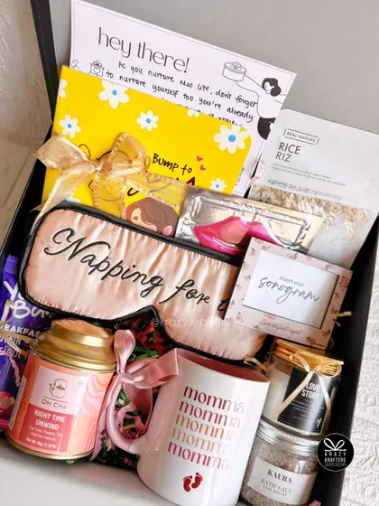 "Napping for two" is the mood! This hamper for the mom-to-be includes a sleep mask, a 'Momma' mug, relaxing bath salts, and a sonogram frame.