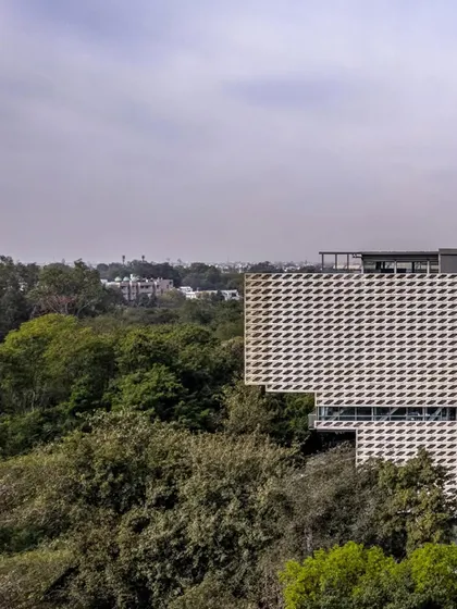 The Mankind HQ is surrounded by a dense green edge, and the design seeks to continue this dialogue with nature. The building's form is shaped by strategic excavations and shifts in response to light, views, and the desire for increased urban porosity.