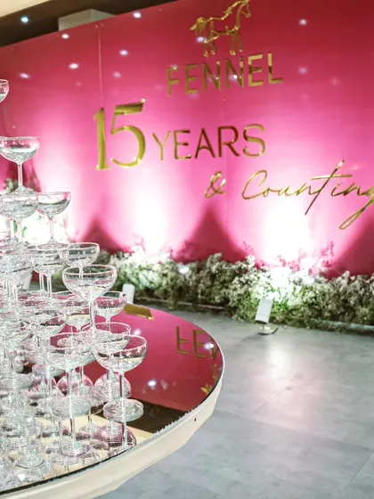 The champagne tower stands ready, reflecting the event's lighting and adding a sparkling centerpiece to the celebration.