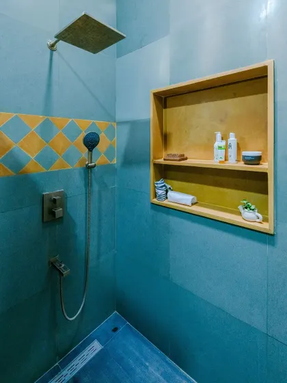 The patterned tiles in this shower add a touch of traditional charm to the modern fittings.