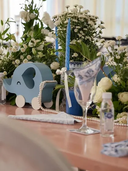 A close-up of the tablescape, featuring a cute blue elephant prop.