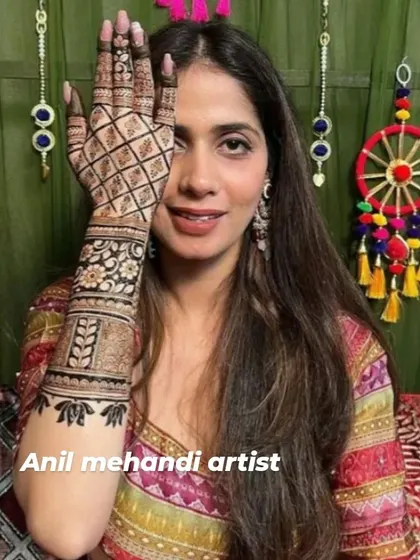 A beautiful client showing her elegant one-hand mehendi design. The checkered pattern on the palm is a modern and popular choice.
