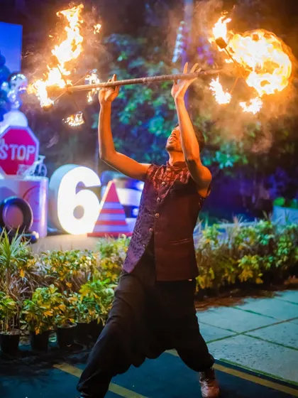 A fire dancer manipulates a flaming staff, creating a spectacular show for the guests. This kind of dynamic entertainment makes for incredible photos and unforgettable memories.