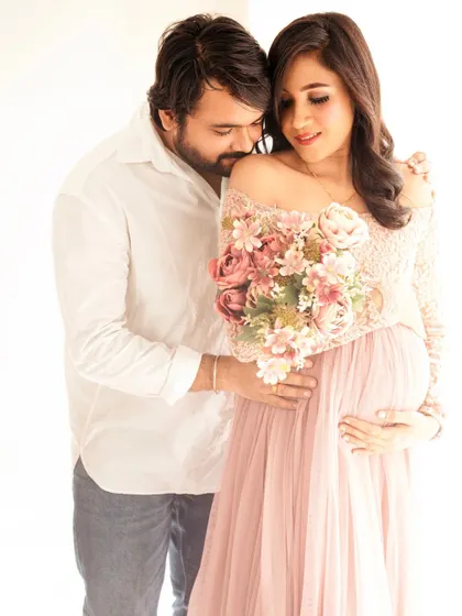 A close-up of a tender embrace. The bouquet of flowers adds a beautiful texture and focal point to this romantic couple's shot.