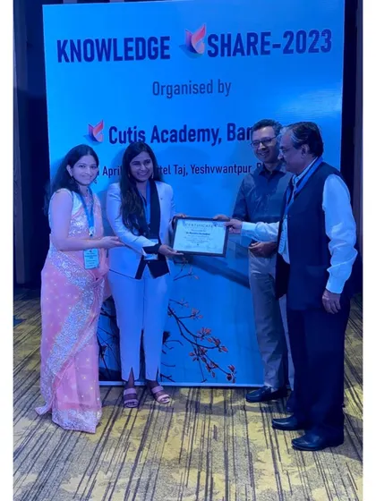 Receiving my certificate on stage, a proud moment recognizing my contribution to the academic event.