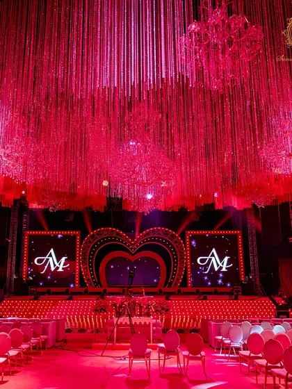 A head-on view of the performance stage, with the couple's monogram glowing on the LED screens, ready for the Sangeet night's festivities.