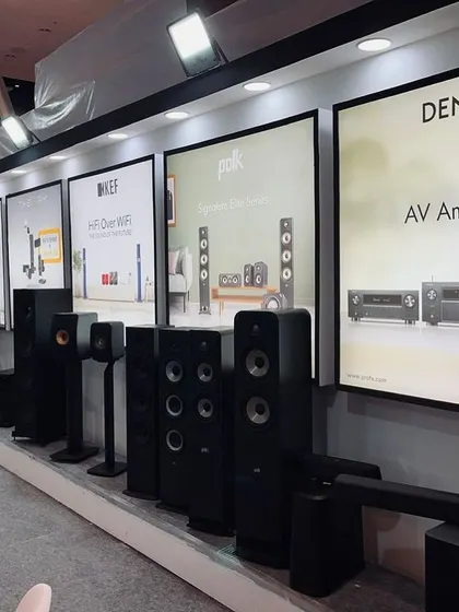 Our product display wall at the Smart Home Expo, featuring a curated lineup of speakers and AV amplifiers from leading brands like KEF, Polk, and Denon. This setup allows for easy comparison and detailed discussions with clients.