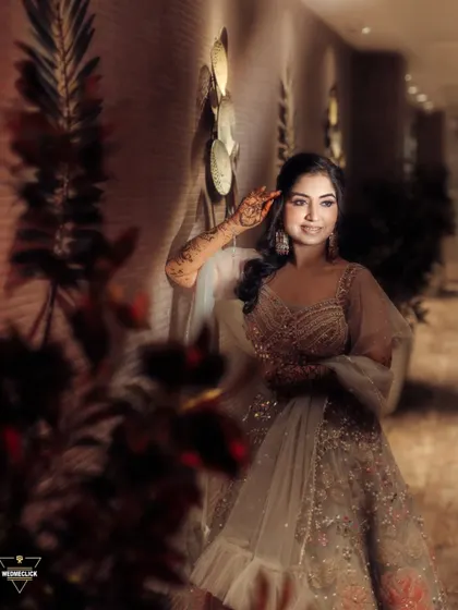 A solo portrait of the bride, her elegant gown and gentle smile captured in warm, flattering light.