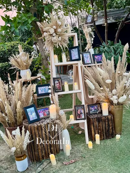 A daytime view of the memory ladder, showing the natural textures of the wood, pampas grass, and the surrounding greenery.