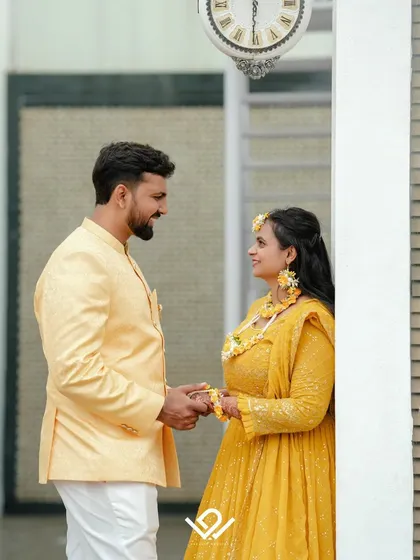 A quiet, romantic moment amidst the Haldi festivities, with the couple sharing a look.