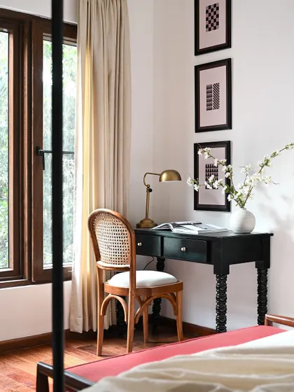 Every bedroom needs a quiet corner. In this master bedroom, I created a small, elegant desk space by the window. The classic writing desk and cane-back chair provide a functional spot for work or reflection without disrupting the room's tranquil atmosphere.