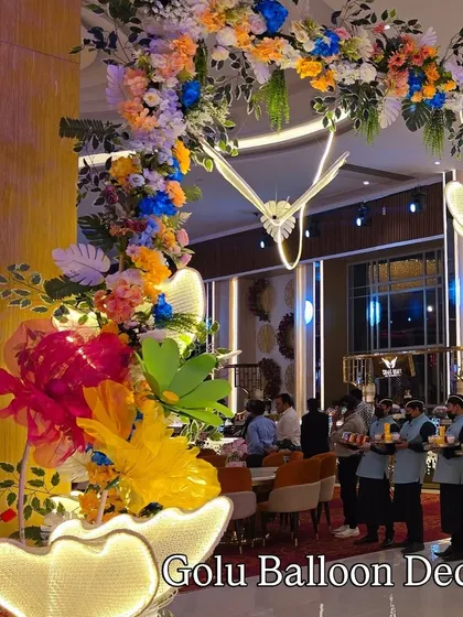A beautiful floral and butterfly archway inside the party venue, creating a whimsical atmosphere for guests.