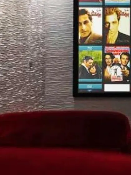A close-up of the viewing experience in one of our installations. The combination of a high-contrast screen, plush velvet seating, and professionally treated walls ensures an authentic and comfortable cinematic session.