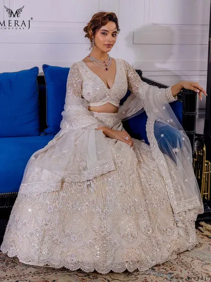 A full view of the ivory lehenga, showcasing its timeless silhouette and intricate hand embroidery, perfect for the bride who defines elegance on her own terms.