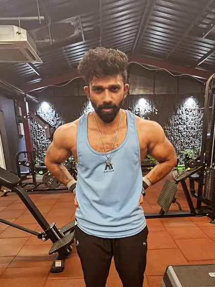 A powerful front-facing stance. This pose emphasizes shoulder width and a tapered waist, key elements of a classic bodybuilding aesthetic.