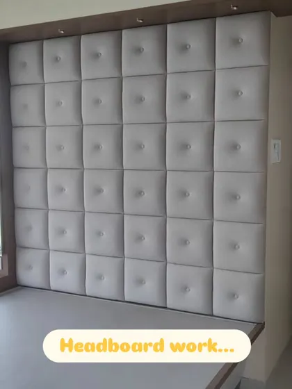 A floor-to-ceiling, wall-to-wall headboard I created for a client. The grid of square, button-tufted panels adds a sense of luxury and comfort to the bedroom.