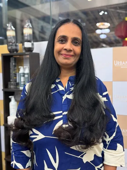 A full-length view of the long layered haircut, showcasing the healthy shine and beautiful shape.