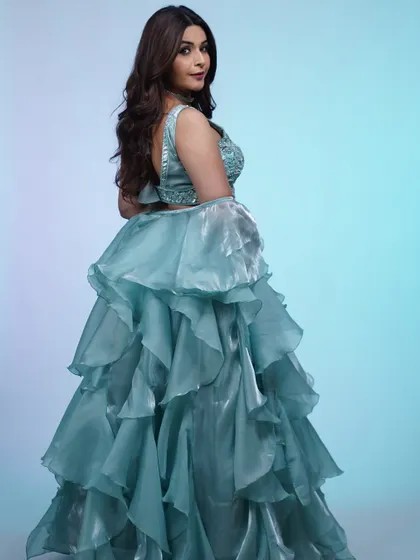 The back of this sky-blue lehenga is just as beautiful, with a simple strap design that complements the voluminous ruffled skirt.