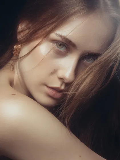 An intimate, close-up portrait that captures a soft, glowing look. The skin looks healthy and radiant.