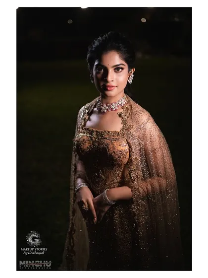 A full portrait of Sindhu at her engagement party. The makeup is glamorous yet sophisticated, creating a cohesive look with her high fashion Dolly J Studio gown.