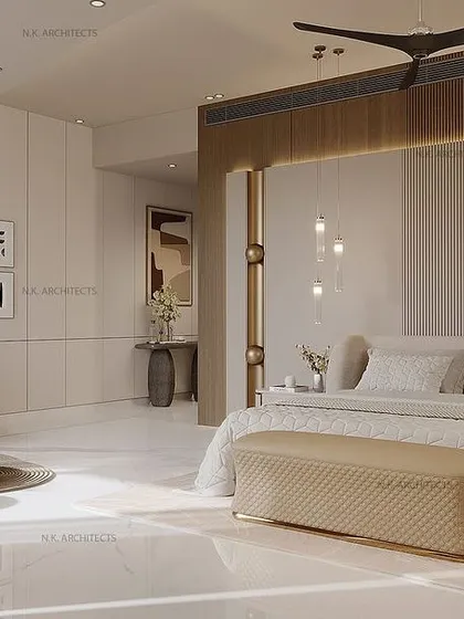 A wider shot of the large, open-plan bedroom, showing the spacious layout and the seamless integration of the sleeping and living areas. The design focuses on creating a refined and glamorous personal space.