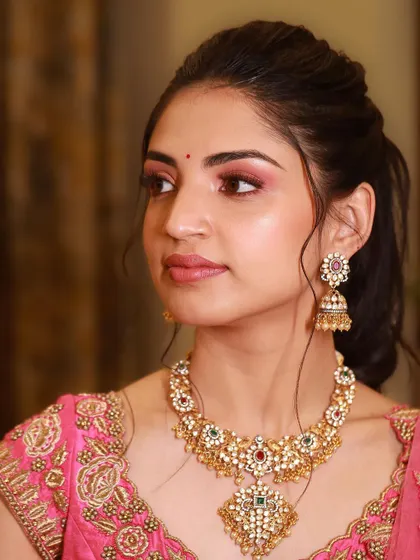 A three-quarter profile view that showcases the cheek contour and the beautiful shape of the eye makeup.