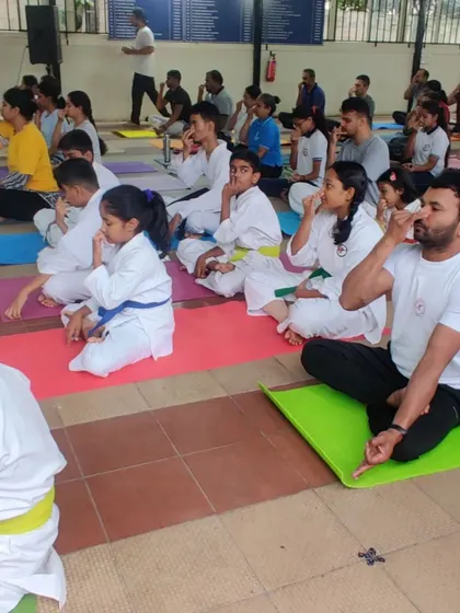 A mixed group of kids and adults engaged in a breathing exercise session. I believe mental fitness is just as important as physical fitness, and pranayama is a key part of that.