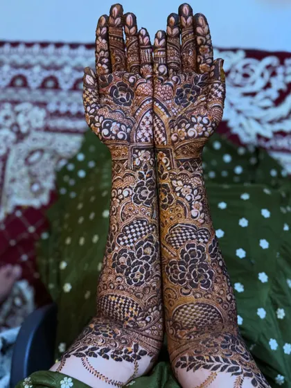 A full view of the traditional bridal henna with elephant motifs, showcasing the rich and dense patterns.