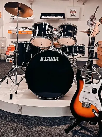 A classic pairing: a Tama drum set and a Fender Stratocaster. This setup represents the foundation of countless rock bands and is a common sight on our store floor.