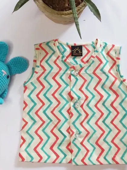 A chevron print jhabla in red and teal. The vibrant pattern adds a fun touch to this simple and comfortable infant top.