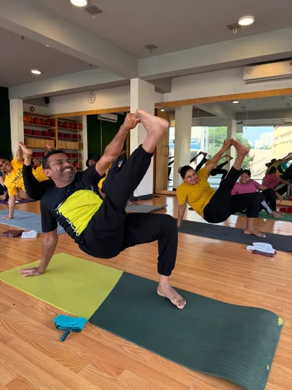 Students challenge themselves with a dynamic balancing pose, showing strength and determination.