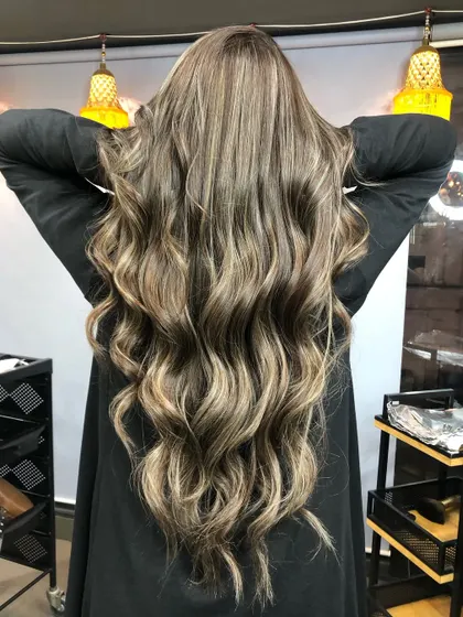 Cool tones are the new trend. This rich platinum blonde balayage with a global color is a testament to how stunning cool hues can be.