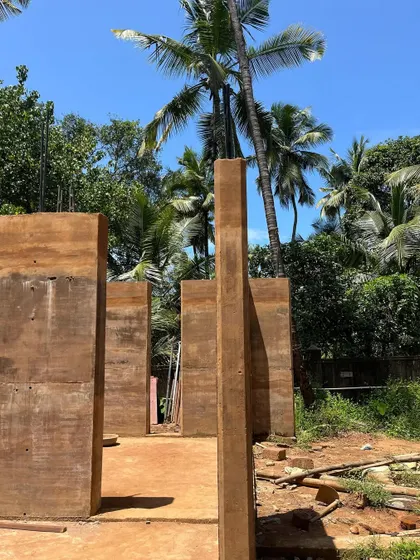 The beauty of raw construction at our Morjim site. Here, freestanding rammed earth walls stand against the sky, their layered textures waiting to become part of a finished home. This is building with the land itself.