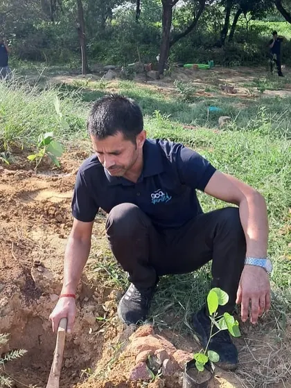 A volunteer from Bacardi digs a pit for a new sapling, contributing to the revival of a forest that had been suffering from soil contamination and water loss.