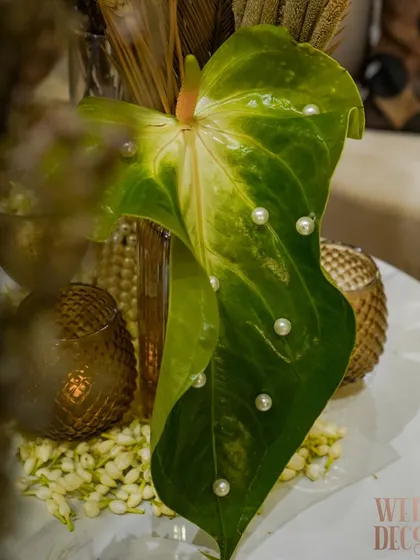 A single anthurium leaf is transformed into a piece of art with delicate pearls placed on its surface. This is an example of the small, thoughtful details that elevate our designs.