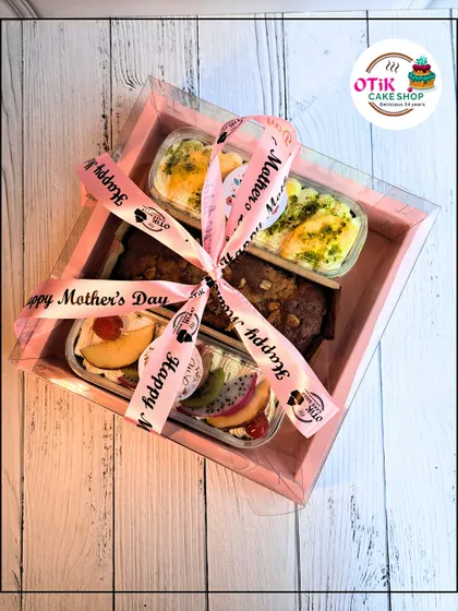A pink gift box for Mother's Day filled with an assortment of my popular cake tubs, including fruit, chocolate, and brownie flavors.