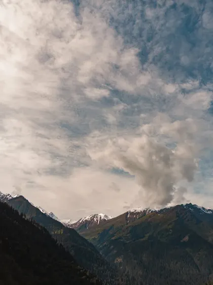 An epic view of the snow-capped peaks from Tosh village in Parvati Valley. This demonstrates that even with a simple phone camera, a good eye for composition and lighting can capture the grandeur of the Himalayas.