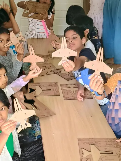 Mission accomplished! The kids proudly display their newly assembled fighter jets, ready for the next step: painting and customization.