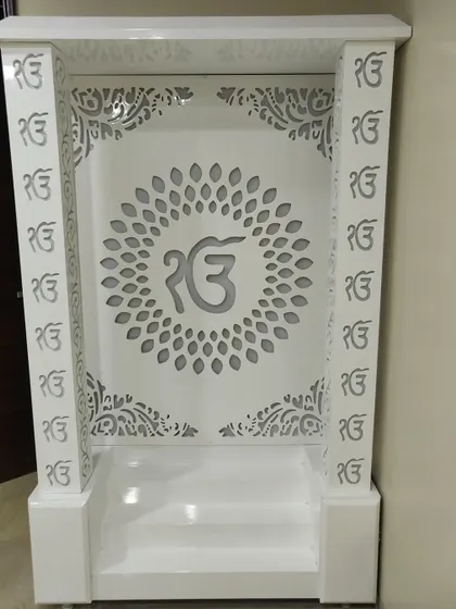 A frontal view of the 'Ek Onkar' mandir, showing the precision of the jali work on the pillars and back panel.