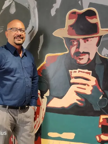 A duplicate shot of a Centrix team member posing with his mural counterpart.